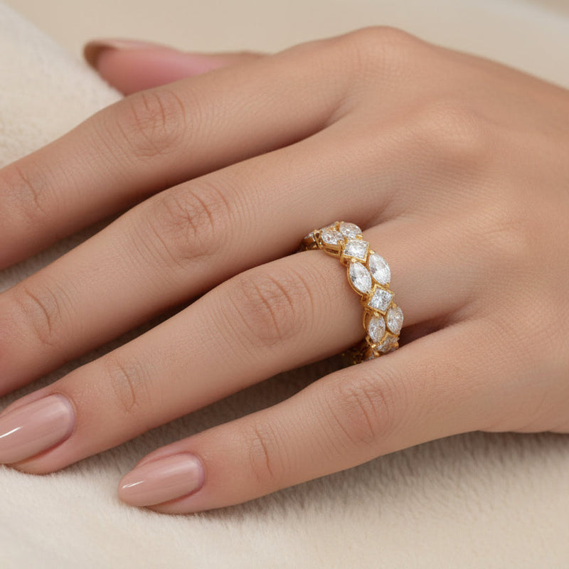 Yellow gold cluster diamond ring with oval diamonds in a wrap-around design on hand.