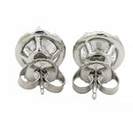 Round white gold diamond stud earrings with halo design and brilliant cut stones.