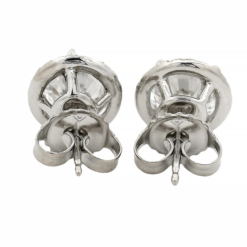 Round white gold diamond stud earrings with halo design and brilliant cut stones.