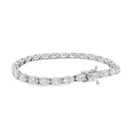 White gold tennis bracelet with oval-cut diamonds in a linked setting.