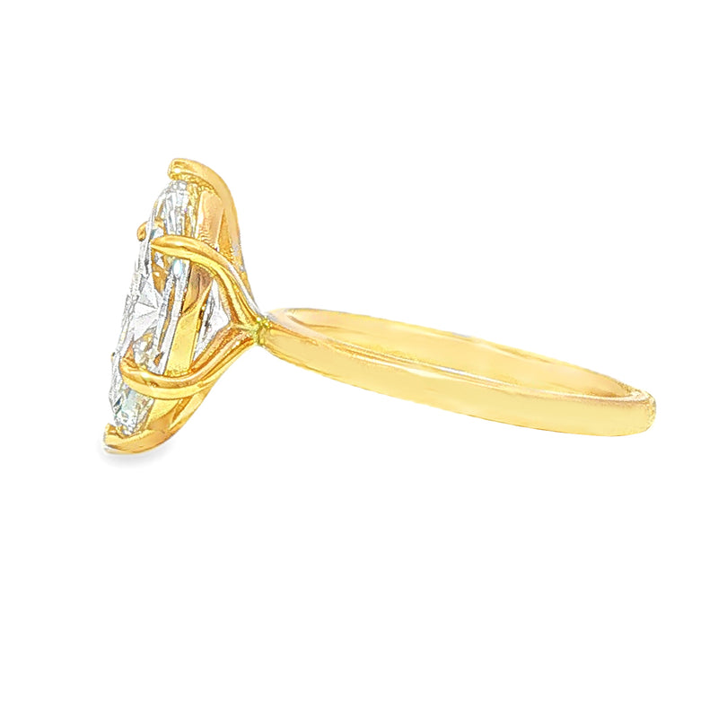 14k gold engagement ring with marquise-cut diamond solitaire and delicate prong setting.