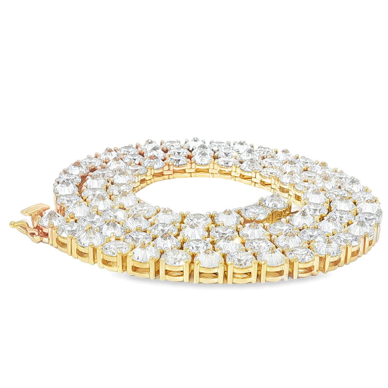 Yellow gold tennis chain with alternating upside down round diamonds.