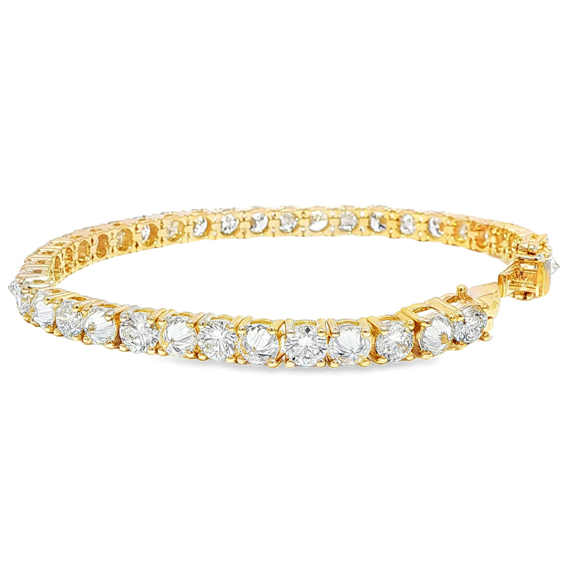 Yellow gold tennis bracelet with alternating upside-down round diamonds in secure clasp.