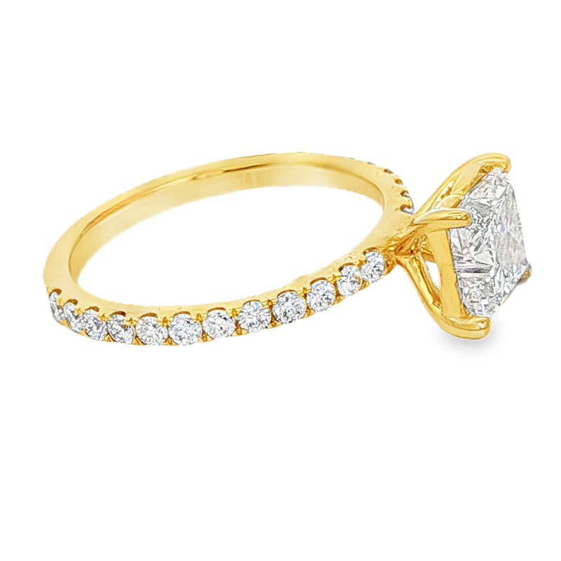 Yellow gold engagement ring with flower cut diamond center and pavé diamond band.