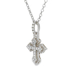 White gold mini cross pendant with sparkling diamond accents on chain.