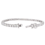 White gold tennis bracelet with alternating upside down round diamonds in a sleek setting.