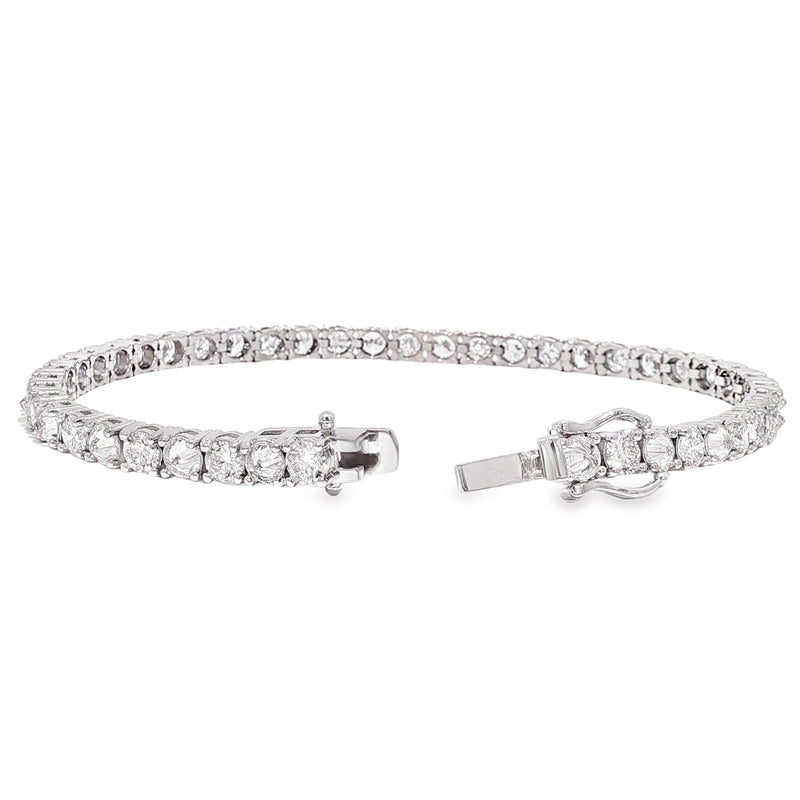White gold tennis bracelet with alternating upside down round diamonds in a sleek setting.
