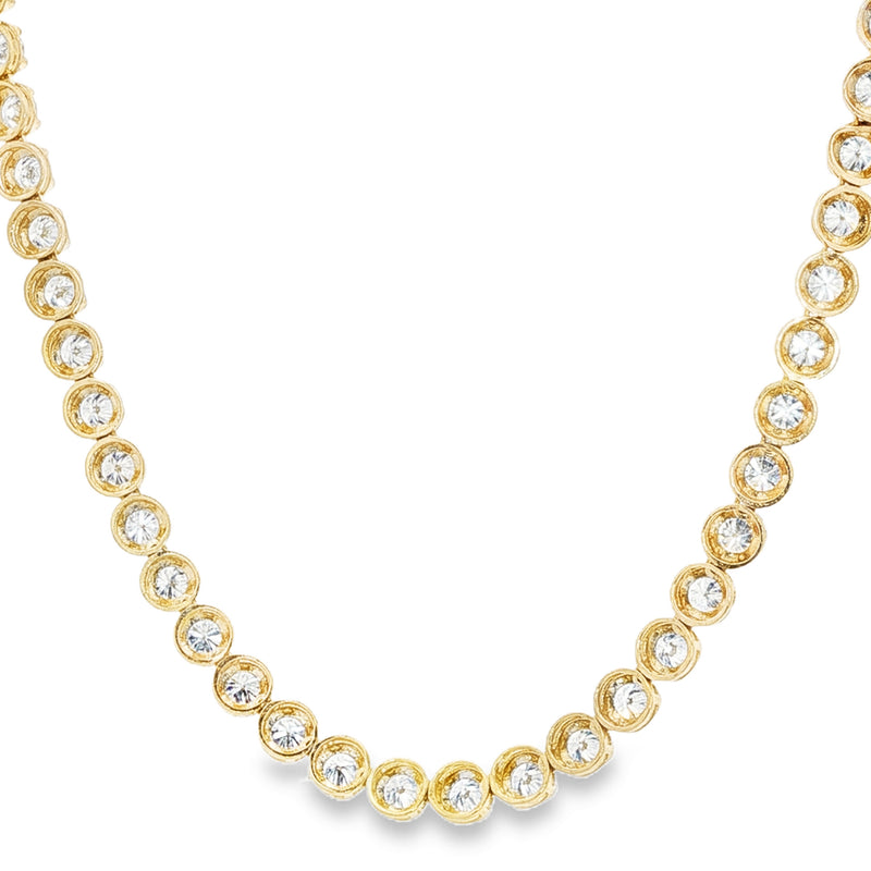 Yellow gold tennis chain necklace with round sparkling diamonds in a classic setting.