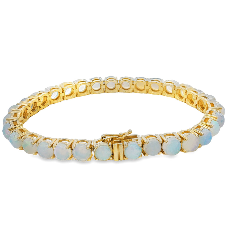 Yellow gold tennis bracelet with round opal gemstones in a secure clasp setting.