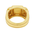 Yellow gold men's ring with double skull design and square diamond cluster center.