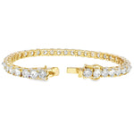 Yellow gold tennis bracelet with alternating upside-down round diamonds in secure clasp.
