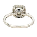 Cushion-cut yellow diamond ring with halo of white diamonds on a white gold band.