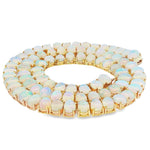Yellow gold chain necklace featuring round luminous opal gemstones in tennis style.