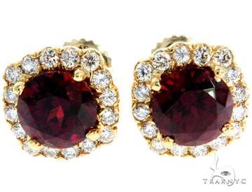 14KY yellow gold stud earrings with red garnet center and surrounding white gemstones.