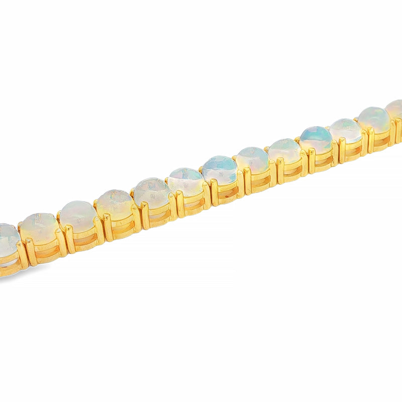 Yellow gold opal tennis bracelet with round gemstone settings and polished finish.