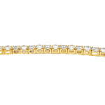 Yellow gold tennis bracelet with alternating upside-down round diamonds in secure clasp.