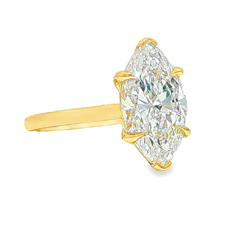 Yellow gold ring with marquise-cut solitaire diamond and four prongs.