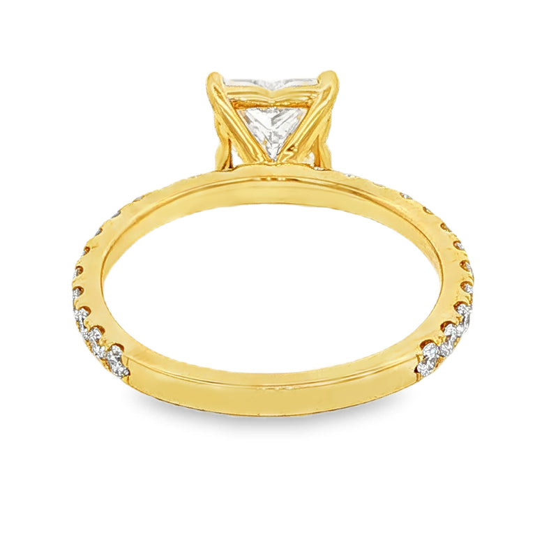 Gold engagement ring with a triangular flower-cut diamond and small side diamonds on the band.