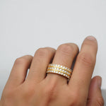 Yellow gold three-row wedding band with round diamonds in a sleek, polished setting.