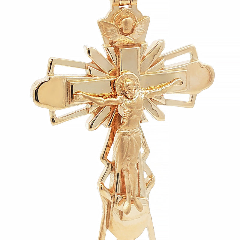 Gold crucifix pendant with detailed Jesus figure and decorative cut-out cross design.