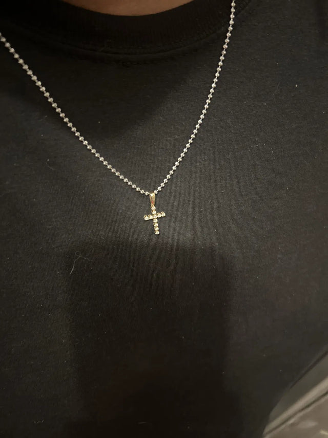 Terynce D. wearing the 14K Gold Diamond Small Cross 65300