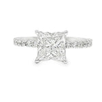White gold engagement ring with flower-cut square diamond and diamond-studded band.