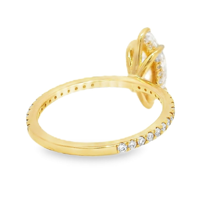 Yellow gold ring with marquise-cut diamond and hidden halo of smaller diamonds on band.