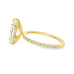 Yellow gold ring with marquise-cut diamond and hidden halo of smaller diamonds on band.