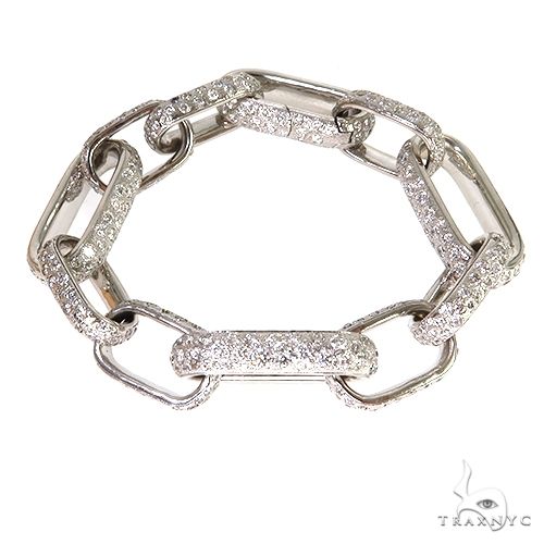 Custom diamond link bracelet in gold with pave-set round diamonds across fancy link design, front view