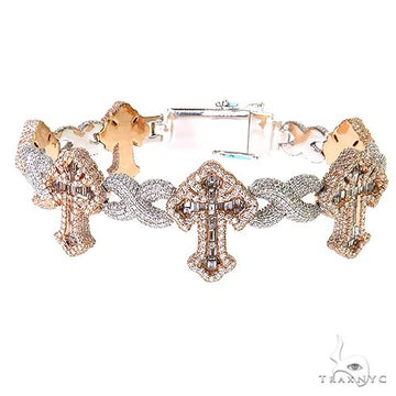 Baguette diamond fleur de lis cross bracelet in gold – fancy link construction with repeating cross motif, flat lay angle