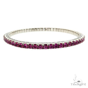 Stretch bangle bracelet in 14k gold with gemstone accents – front angle showing flexible band