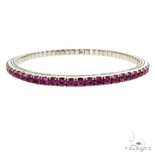 Stretch bangle bracelet in 14k gold with gemstone accents – front angle showing flexible band