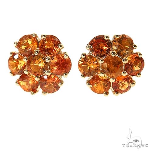 Large flower cluster earrings with green sapphire stones arranged in a multi-petal setting