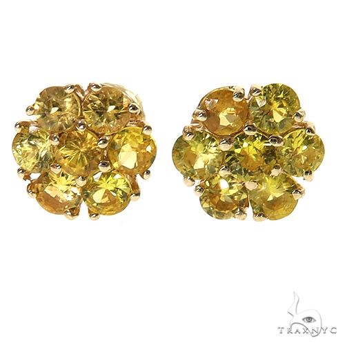 Large flower cluster earrings with green sapphire stones arranged in a sunburst petal setting