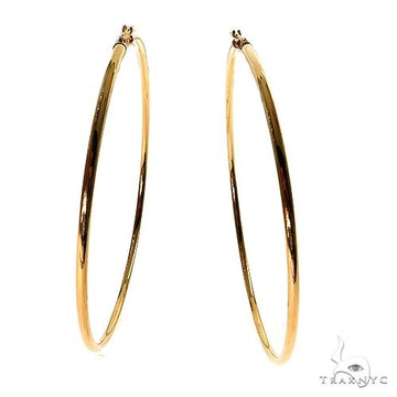 14k yellow gold hoop earrings, 70mm diameter, polished finish — front-facing pair view