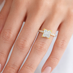 Yellow gold engagement ring with square flower-cut diamond and diamond-studded band.