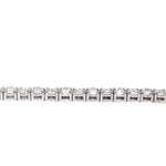 White gold tennis bracelet with alternating upside down round diamonds in a sleek setting.