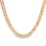 Yellow gold tennis chain with alternating upside down round diamonds.