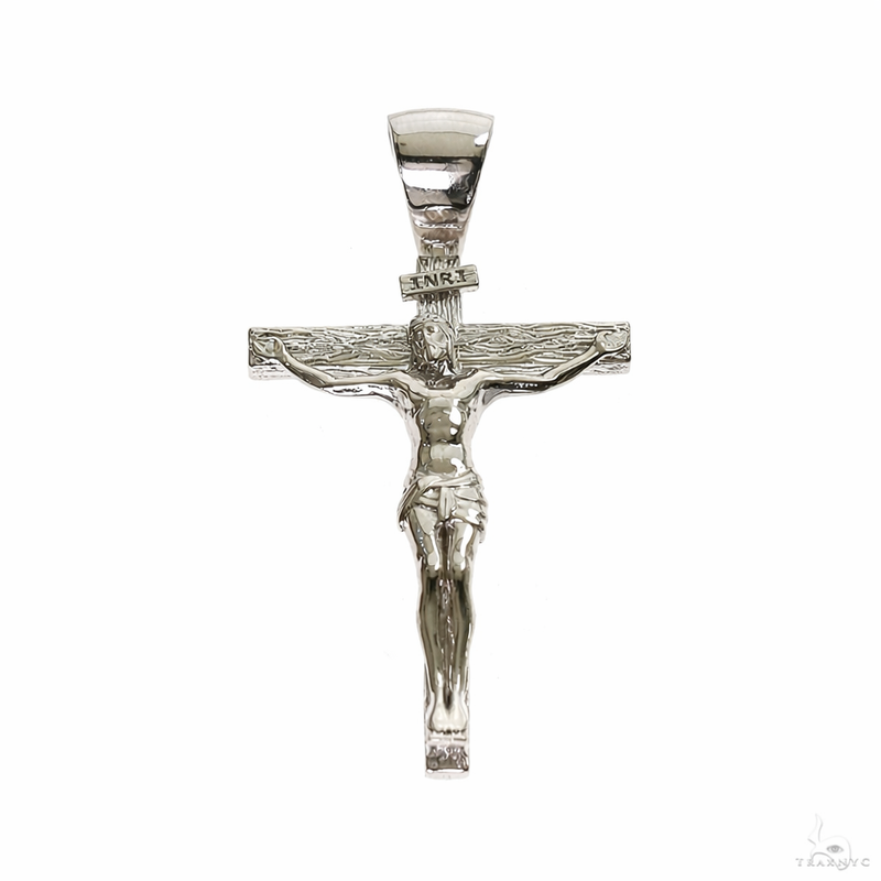 Small silver crucifix pendant with detailed Jesus figure and INRI plaque.