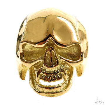 Polished 18K yellow gold men's skull ring with detailed hollow eye sockets and teeth design.