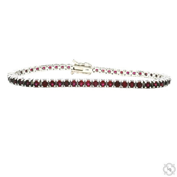 3.00mm ruby tennis bracelet in white metal setting with secure box clasp.