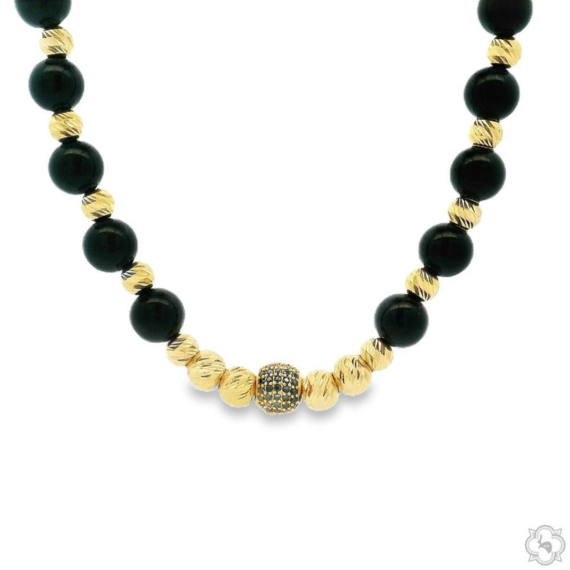 Black and gold bead necklace with textured gold and rhinestone accent beads