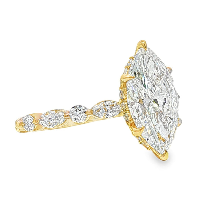 2 ct marquise diamond engagement ring with gold band and round diamond accents.