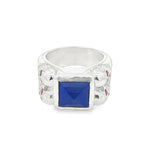 Silver ring with square blue lapis, skull details, and small red sapphires.