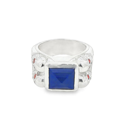 Silver ring with square blue lapis, skull details, and small red sapphires.