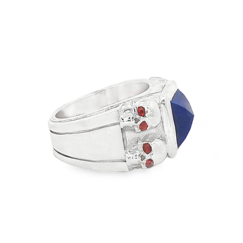 Silver ring with square blue lapis, skull details, and small red sapphires.