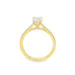 Pear-shaped diamond engagement ring in yellow gold with detailed band accents.