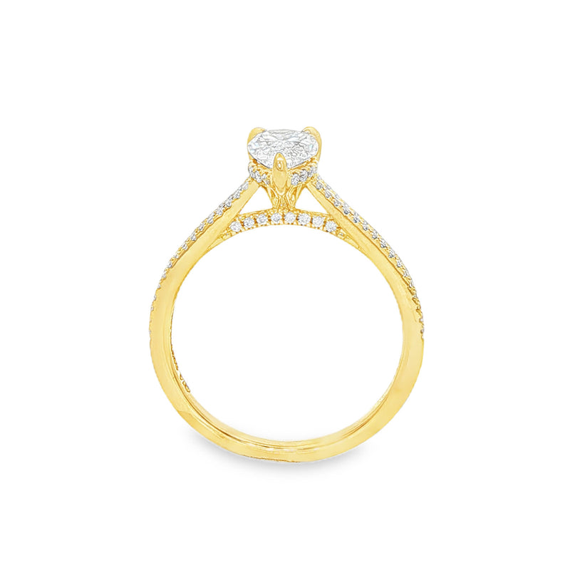 Pear-shaped diamond engagement ring in yellow gold with detailed band accents.
