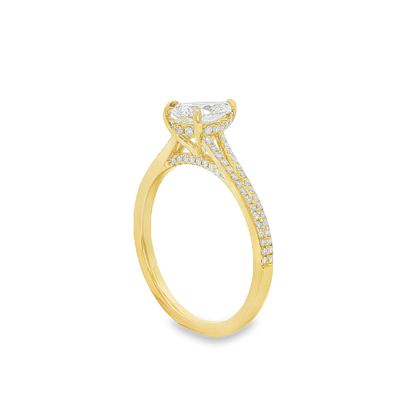 Pear-shaped diamond engagement ring in yellow gold with detailed band accents.