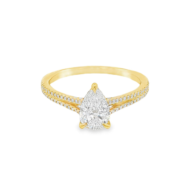 Pear-shaped diamond engagement ring in yellow gold with detailed band accents.